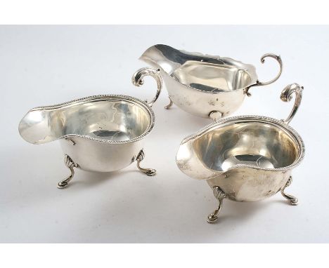 A PAIR OF 20TH CENTURY SAUCE BOATS with leaf-capped flying scroll handles, by S. Blankensee & Sons, Birmingham 1939 and anoth