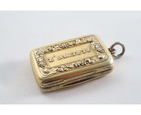 A GEORGE III SILVERGILT VINAIGRETTE oblong with rounded corners and an engine-turned base, the cover with the raised letters 