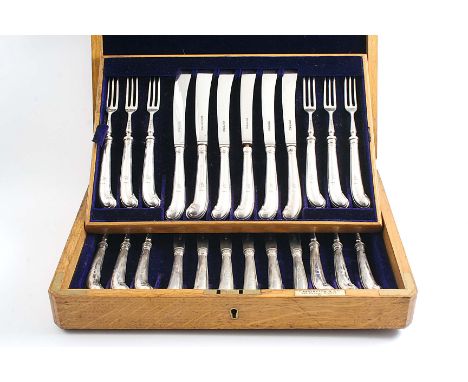 A LATE VICTORIAN CASED SET OF TWELVE PAIRS OF DESSERT/FRUIT KNIVES & FORKS with pistol handles, crested & loaded, by Harrison