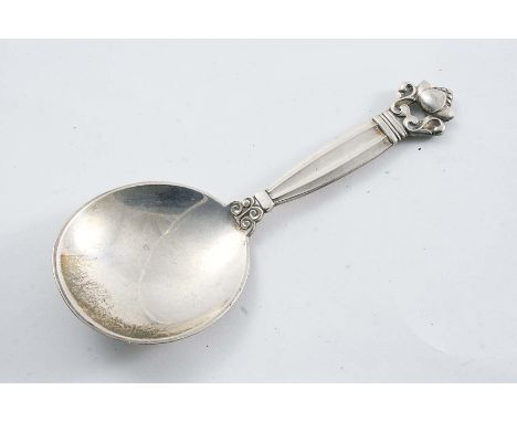 BY GEORG JENSEN:- A Danish pre-war Acorn pattern caddy spoon with English import marks for London 1931;  4"  (19.2 cms) long;