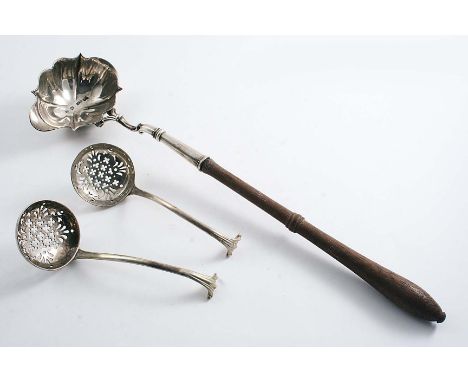 A GEORGE II TODDY LADLE with a turned wooden handle with a single-lipped, shaped oval bowl, crested, by Edward Aldridge, Lond