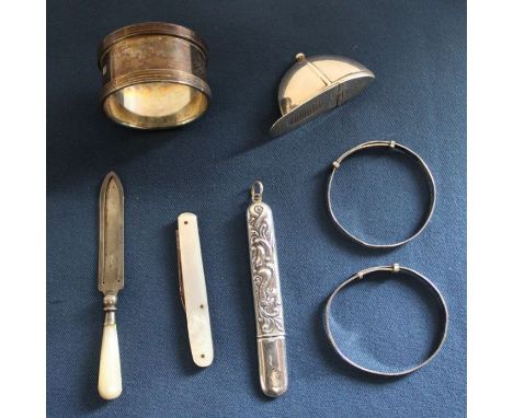 Silver vesta case in the form of a jockey's cap marked 925, silver serviette ring marking British Engine centenary, silver ne