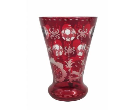 An antique glass cup in the shape of a cone, made of Ruby Glass, decorated with hand engraving in the model of a deer and a t