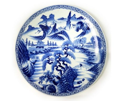 A large Japanese ceramic plate (Charger), decorated with cobalt blue hand painting on a white background, signed Diameter: 46