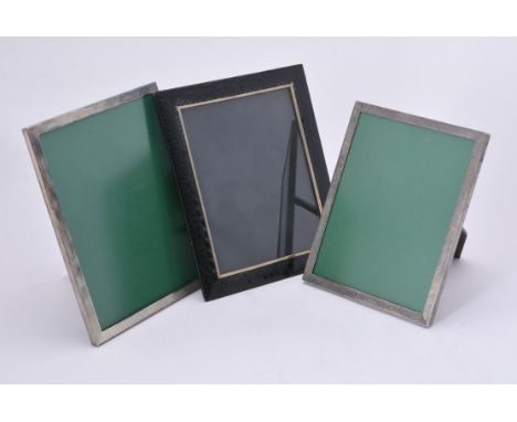 
	
		Asprey, a pressed leather photo frame, 28.5cm (11 1/4in) high; and Asprey, two electro-plated photo fame, with engine tu
