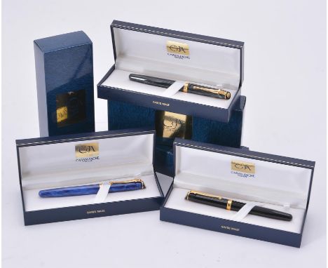
	
		Caran d'Ache, three roller ball pens, to include: a black roller ball pen, the cap with a gilt clip and cap band, with a