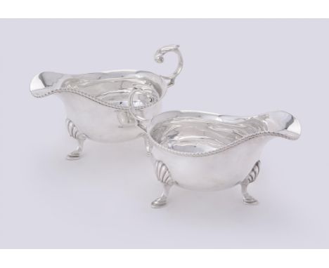 
	
		A pair of silver oval sauce boats by Harrison Brothers &amp; Howson, Sheffield 1930, with leaf capped flying scroll hand