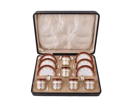 
	
		A set of six silver gilt coffee cup holders by Adie Bros, Birmingham 1926, pierced with arcading, with inserts and sauce