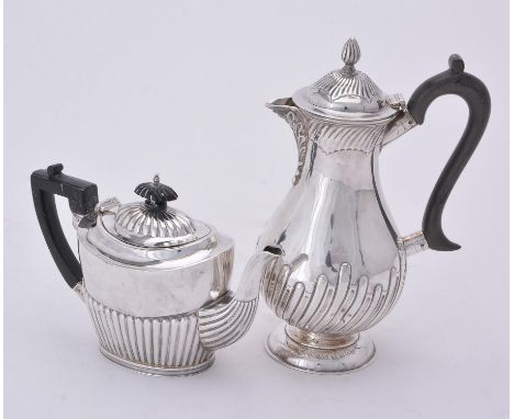 
	
		A Victorian silver baluster coffee pot by William Hutton &amp; Sons Ltd., London 1894, with a wrythen finial to the dome