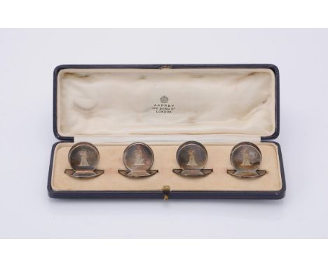 
	
		A cased set of four silver circular menu holders by Asprey &amp; Co. Ltd., London 1924, engraved with a crest, 3cm (1 1/