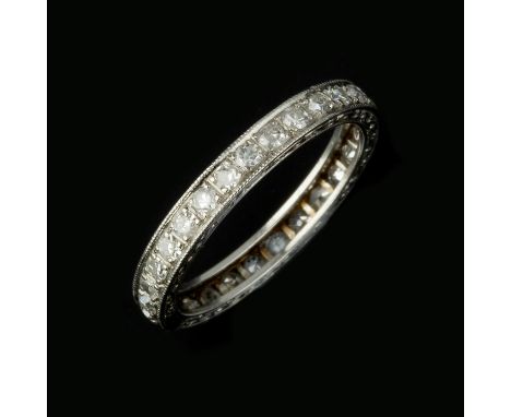 
	
		A diamond eternity ring, the band set with eight cut diamonds, approximately 0.70 carats total, to scroll engraved sides