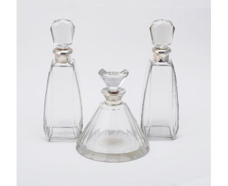 
	
		Three silver mounted decanters with silver collars, a matched pair by Wilmot Manufacturing Co., Birmingham 1923 and 1925
