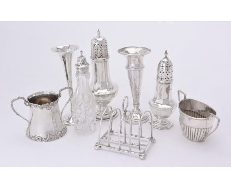 
	
		A collection of silver items, to include: a baluster castor by Gorham Manufacturing Co., Birmingham 1918, with an orb fi