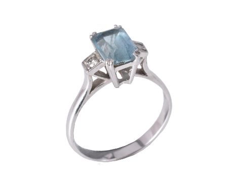 
	
		An aquamarine and diamond three stone ring, the central step cut aquamarine claw set between brilliant cut diamond shoul