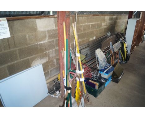 A quantity of long handled gardening tools, curtain poles etc