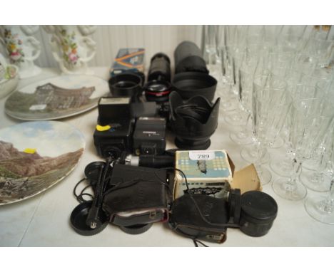 A collection of camera accessories to include flask units and lenses