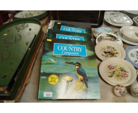 Three folders of "The Country Companion" and a pair of black out curtains
