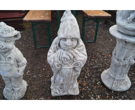 A concrete garden ornament in the form of "The Gate Keeper"