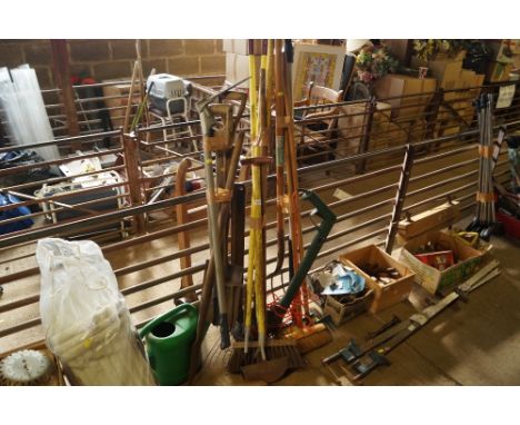 A quantity of long handled gardening tools