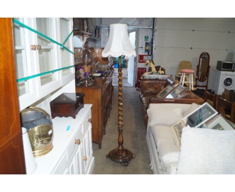 An oak barley twist standard lamp with shade