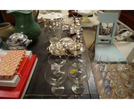 A collection Champagne saucers, glass jug and a collection of silver plated ware to include cruet set, cream jug, sugar bowl 