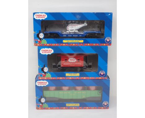 A boxed Lionel 0 gauge Thomas the Tank Engine Series 'Bobber Caboose', 'Gondola with Canisters' and ' Flatcar with Harold the