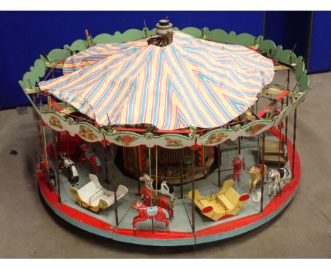 An electric operating large scale Model of a Fairground Merry-go-Round 4ft D x 3ft H 