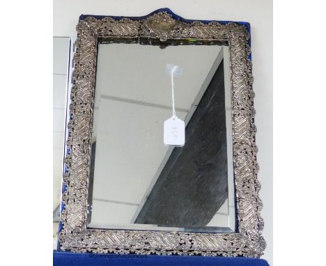   A large Edwardian repousse silver mounted easel mirror with pierced scrolling border, Henry Matthews, Birmingham, 1901, 48.