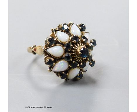   A yellow metal (stamped 18k), white opal and sapphire cluster set 'hareem' ring, size O, gross 6.6 grams.