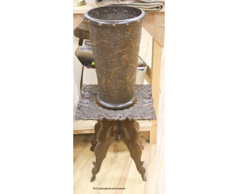   A 19th century carved side table and an Arts and Crafts stamped leather stick stand, height 45cm