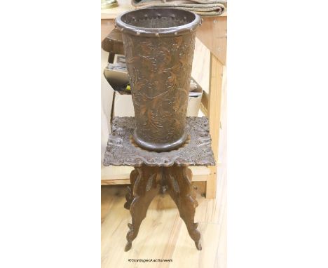   A 19th century carved side table and an Arts and Crafts stamped leather stick stand, height 45cm