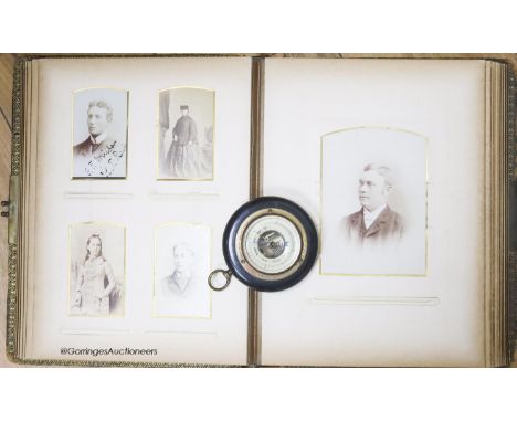   A Victorian monochrome photograph album and an aneroid barometer