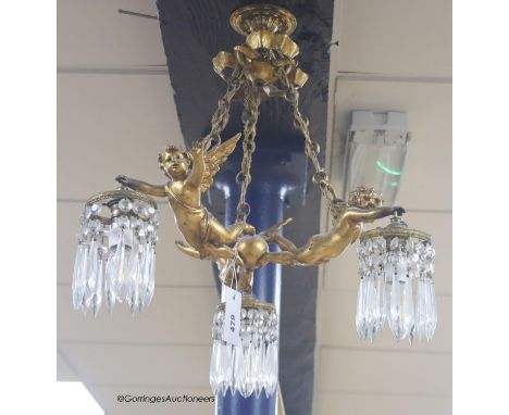  A Louis XV style gilt metal three light ceiling chandelier, mounted with winged amorini, drop 48cm