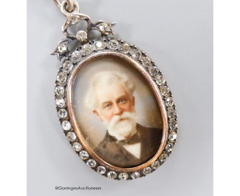 A late 19th century 900 standard gilt white metal and paste set oval pendant locket, inset with portrait of a gentleman, 42mm