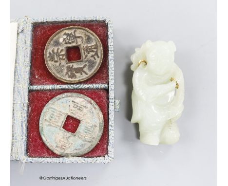   Two Chinese coins and a white jade brooch, 6cm