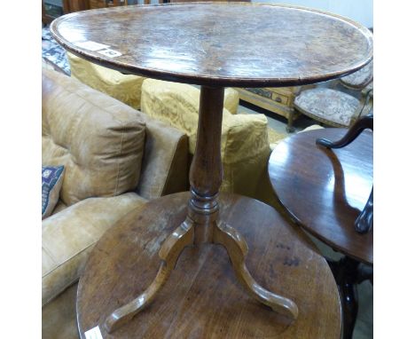   A George III oak and pollard oak circular tilt top tripod tea table (warped) Dia 57 H 67 cms.