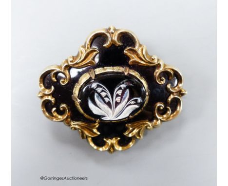 A Victorian yellow metal and two colour enamel cartouche shaped mourning brooch, with engraved inscription dated 1866 and ver