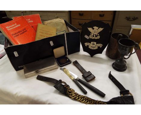 A box of assorted militaria and collectables