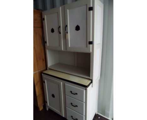A painted kitchen utility unit having enamel tray top