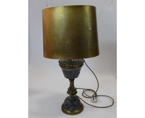 An antique Royal Doulton pottery and brass converted oil lamp, having a trefoil gallery above a tapered reservoir, twisted br