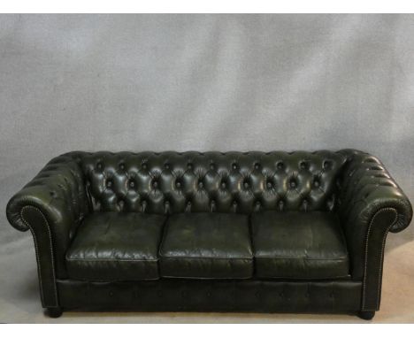 A three seater Chesterfield sofa in buttoned leather upholstery. H.70  L.200 D.85cm 