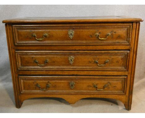A 19th century French Provincial chestnut commode chest of three long drawers on a shaped apron to the moulded supports. H.81