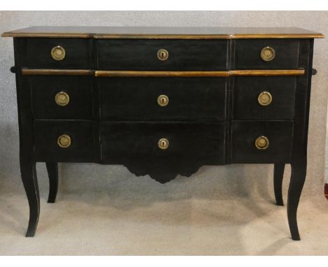 An ebonised and gilt Louis XV style three drawer commode of shaped outline on cabriole supports. H.86 W.121 D.50cm 
