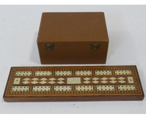 A 19th Century parquetry and bone inlaid cribbage board and pieces along with a wooden cased antique chess set. H.8 L.17 W.12