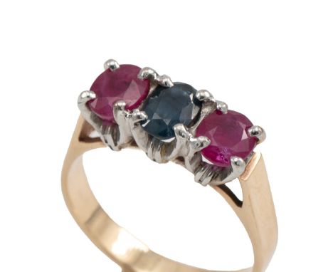 Yellow metal, sapphire and ruby three stone ring in a claw setting with three mixed cut stones, finger size K, unmarked, test