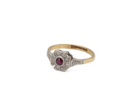 18ct hallmarked gold and platinum set ruby and diamond dress ring, the central ruby set within a four leaf clover, each leaf 