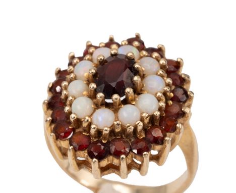 Yellow metal opal, garnet, and ruby set cluster ring of stepped form in a claw setting, stamped "9ct", finger size P and 1/2,