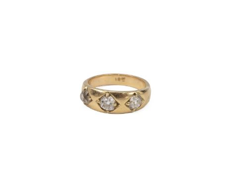 Yellow metal and three stone diamond ring, set with three old cut diamonds, each in a four-claw setting, measuring approximat