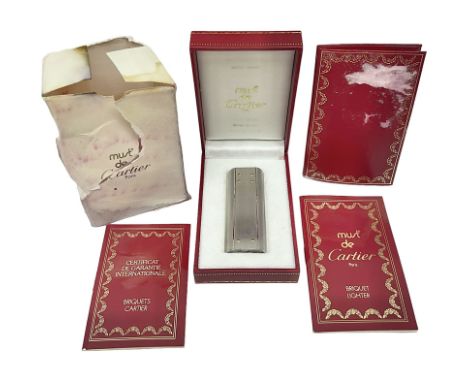 Must de Cartier stainless steel lighter, with gold plated accents, stamped Cartier to base, boxed with guarantee