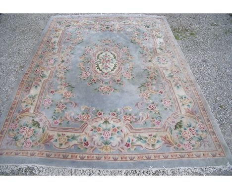 Chinese washed wool blue ground carpet with central floral motif and floral border size approx. 110cm x 366cm